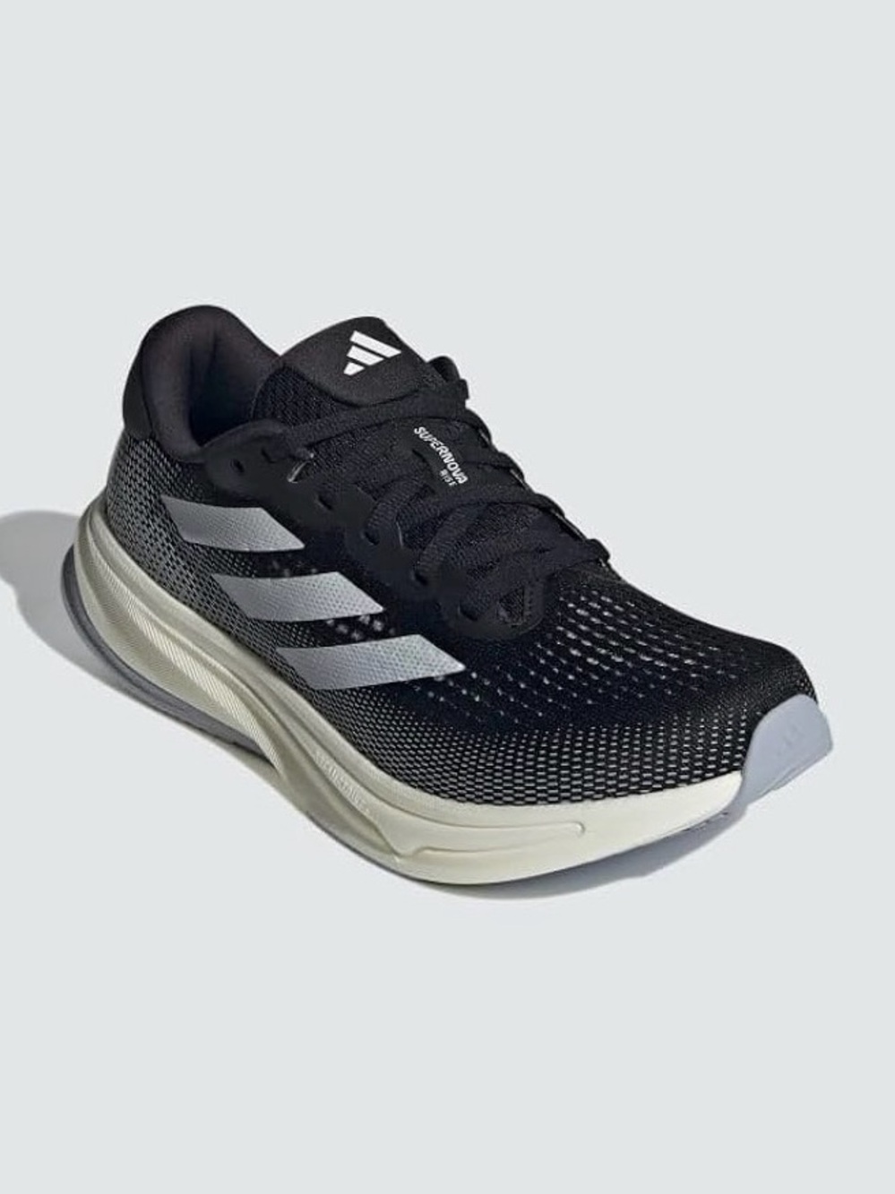 Adidas Supernova Solution stability running shoes in a black, white, and silver